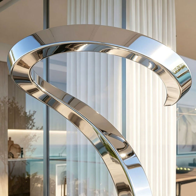 Close-up of mirror polished surface and curved form on abstract stainless steel sculpture