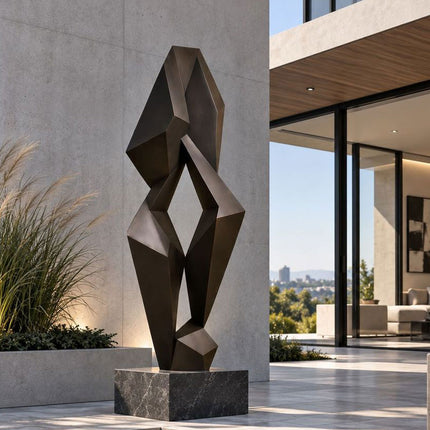Geometric bronze sculpture with angular planes at a contemporary residential entrance
