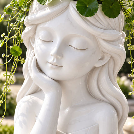 Close-up of a white sculpted girl planter with closed eyes, a hand resting against her cheek, and flowing hair