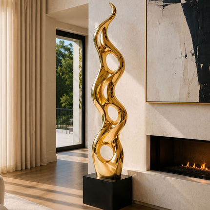 Gold abstract sculpture with flowing curves displayed in a contemporary interior