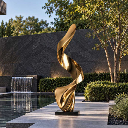 Gold mirror-polished abstract sculpture with a flowing ribbon design on a poolside stone terrace