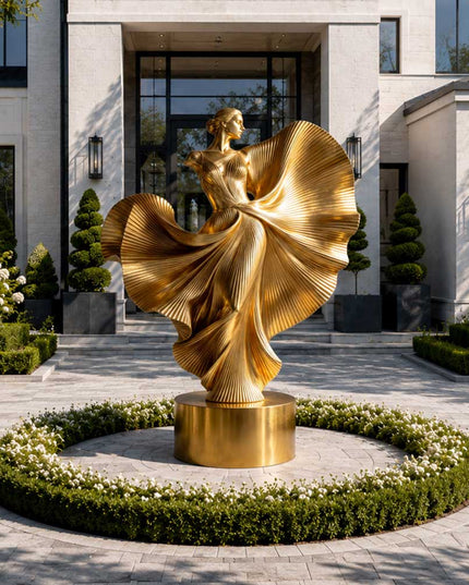 Gold stainless steel female figure sculpture displayed in a luxury residential entrance garden