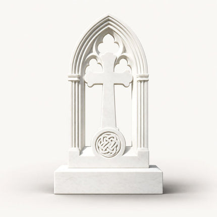 White marble Gothic arch cross headstone with trefoil tracery and Celtic knot medallion.