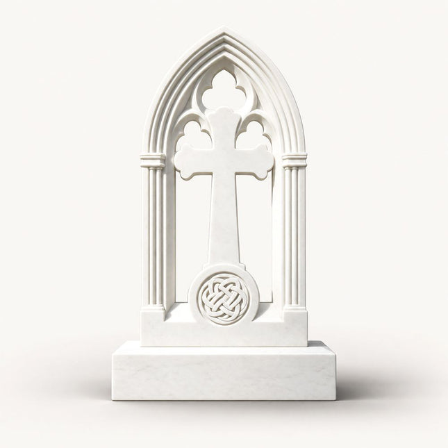 White marble Gothic arch cross headstone with trefoil tracery and Celtic knot medallion.