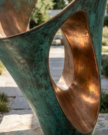 Close-up of bronze sculpture surface showing green patina texture