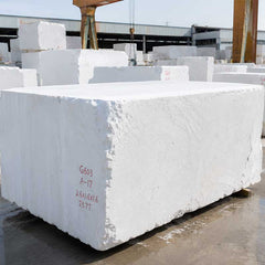Guangxi White marble blocks stored in a stone yard before being selected for handcrafted marble sculpture production.