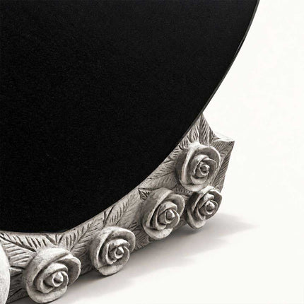 Carved roses and leaves beneath the polished black granite heart memorial panel