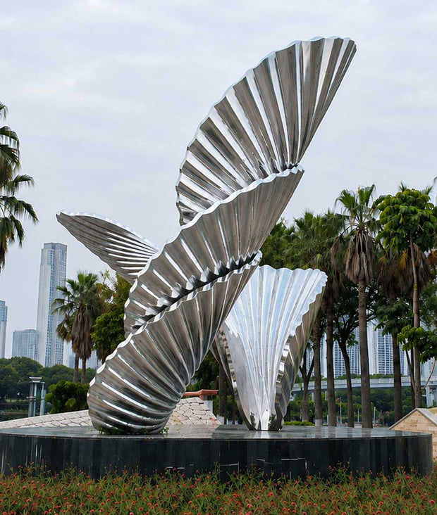 Large stainless steel sculpture installed in an urban landscape