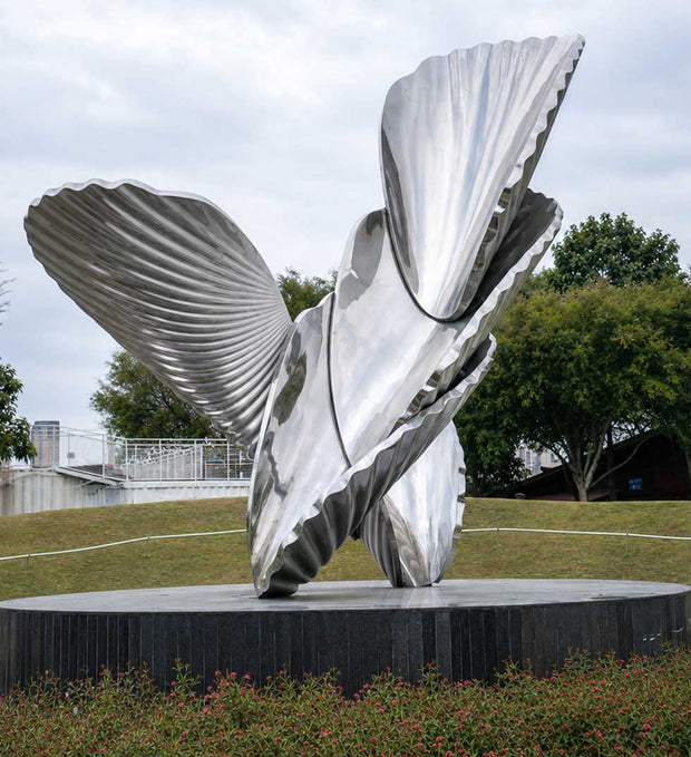 Large polished stainless steel sculpture viewed from the front