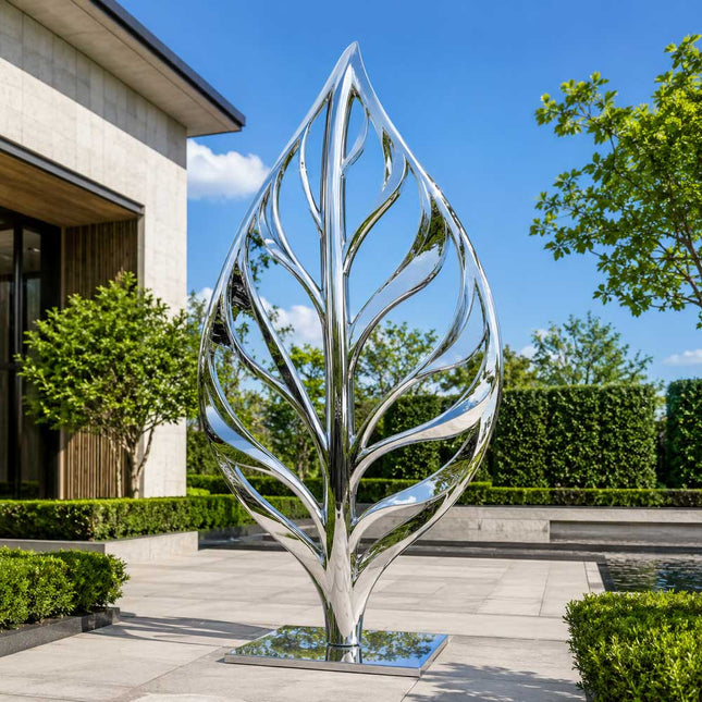 Mirror polished stainless steel leaf inspired sculpture installed in a contemporary garden
