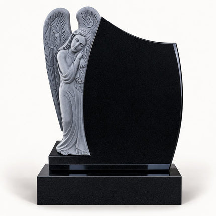 Black granite leaning angel headstone with carved wings and polished memorial panel