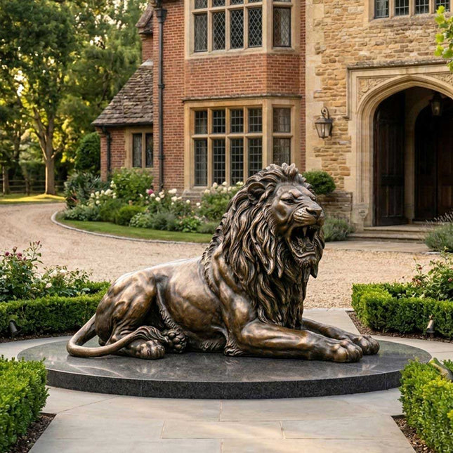 Reclining bronze lion statue displayed in a landscaped estate garden