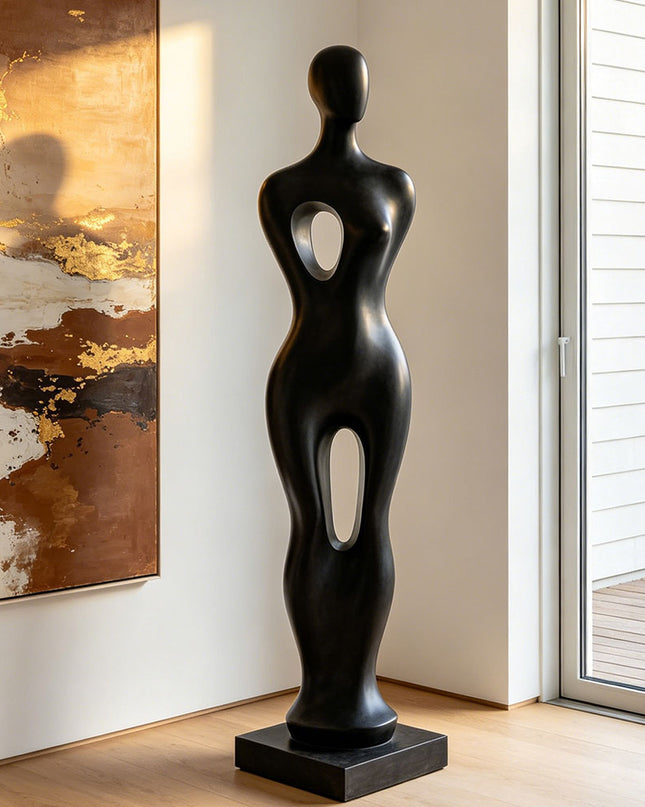 Black abstract sculpture in a modern interior setting with abstract painting and sliding door.