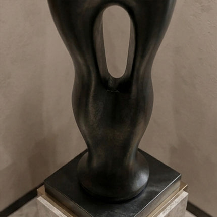 Large contemporary stainless steel sculpture creating a statement in a luxury entryway