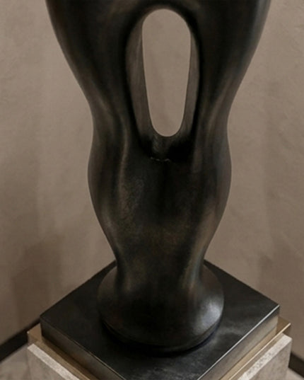 Large contemporary stainless steel sculpture creating a statement in a luxury entryway