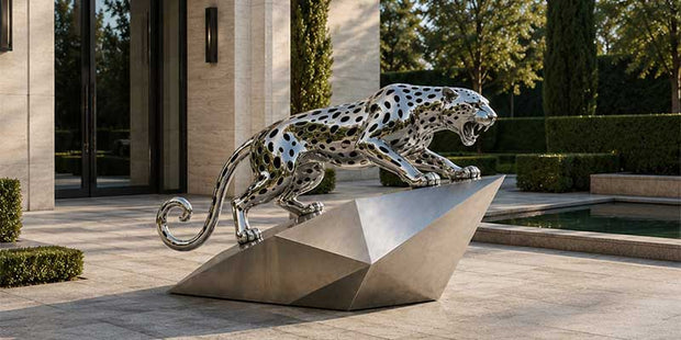 Stainless steel leopard sculpture installed at a luxury residential entrance showing large outdoor sculpture proportions