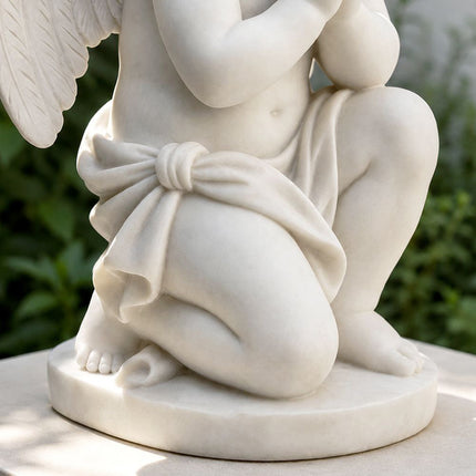 Detailed view of marble angel sculpture carving with drapery and polished stone surface