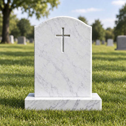 White marble cross headstone with a gently curved top and rectangular base displayed in a grassy cemetery