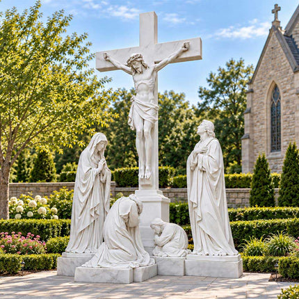 Marble Crucifixion statue with Jesus and surrounding figures displayed in a church garden