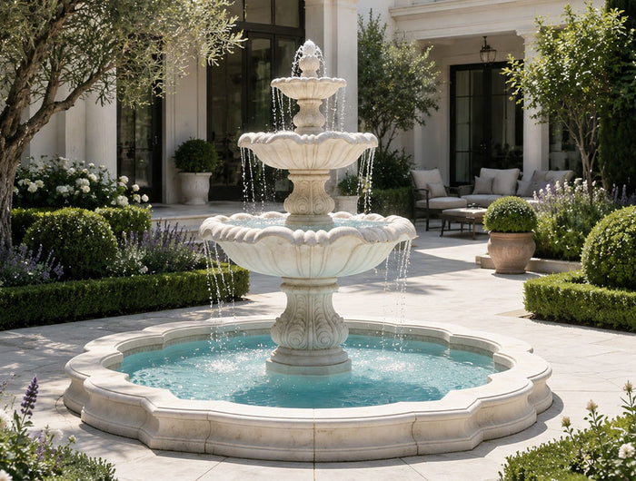 White marble fountain with flowing water installed in a luxury outdoor garden courtyard