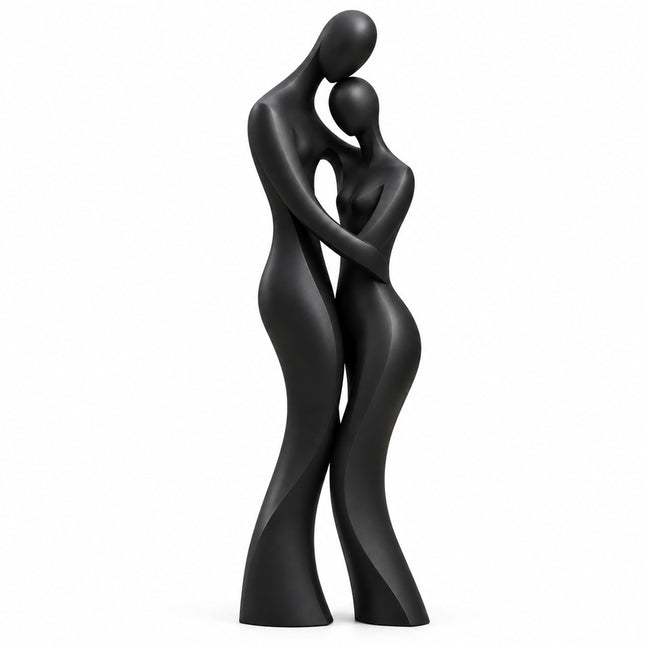 Matte black bronze sculpture of two elongated abstract figures embracing on a white background