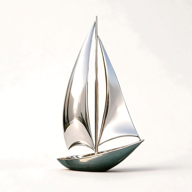 Mirror-polished metal sailboat sculpture with two tall curved sails and a streamlined hull