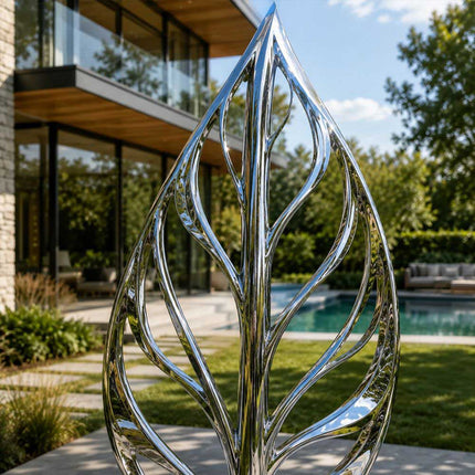Close detail of reflective stainless steel surface and organic leaf structure