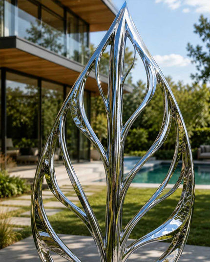 Close detail of reflective stainless steel surface and organic leaf structure