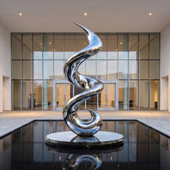 Reflective stainless steel sculpture with polished finish in a contemporary outdoor installation