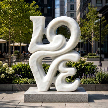 White marble abstract sculpture displayed in a landscaped urban plaza