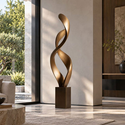 Modern abstract bronze ribbon sculpture with a tall twisting form indoors