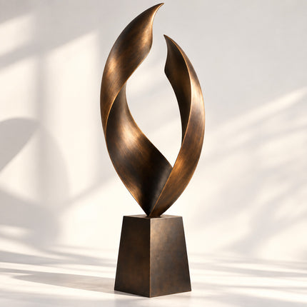 Modern bronze sculpture with twin flowing curved forms and an open center