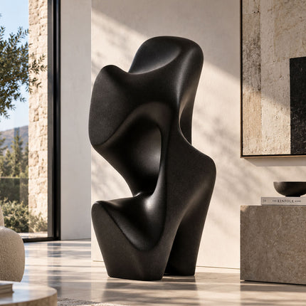 Large black bronze sculpture displayed in a contemporary interior