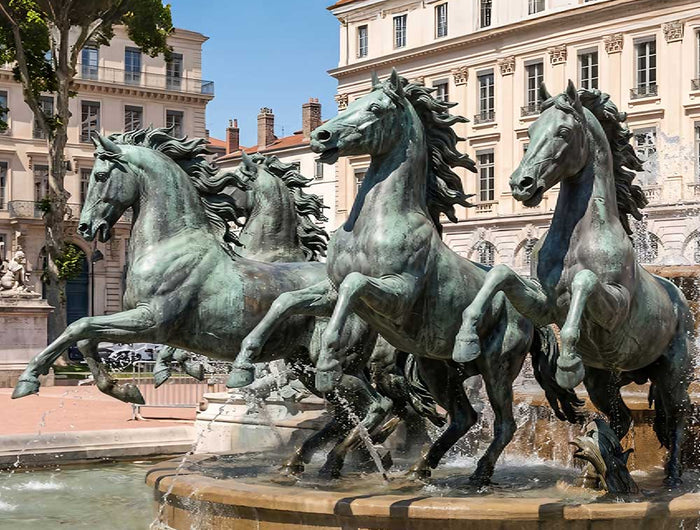 Monumental bronze horse sculptures in a public fountain setting