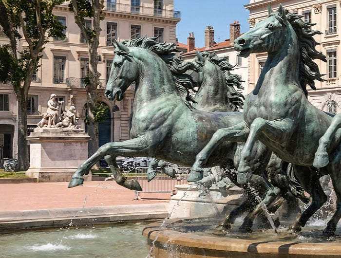 Monumental bronze horse sculptures in a public fountain setting