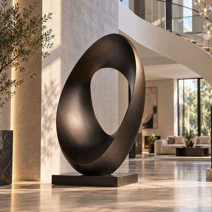 Modern bronze ring sculpture with an organic oval form in a contemporary interior