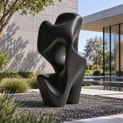 Matte black bronze abstract sculpture in a modern landscaped courtyard