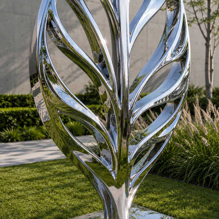 Detail view of flowing lines and polished finish on stainless steel organic sculpture
