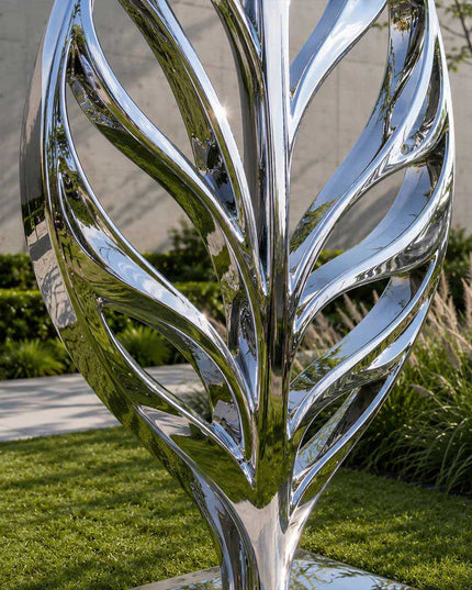 Detail view of flowing lines and polished finish on stainless steel organic sculpture
