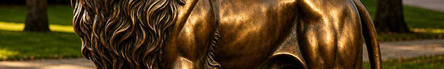 Standing bronze lion sculpture displayed in a landscaped park setting