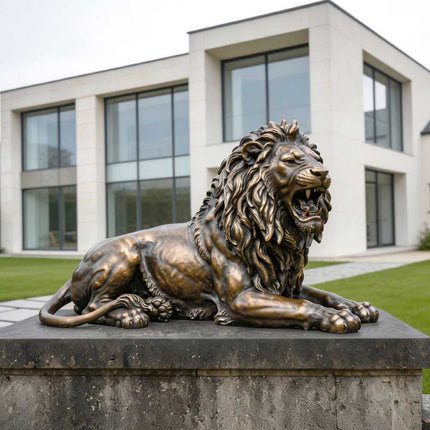 Outdoor bronze lion statue displayed near a modern residence