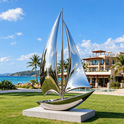 Outdoor metal sailboat sculpture displayed on a lawn overlooking a coastal landscape