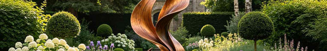 Outdoor sculpture placed in landscape environment interacting with natural light and surroundings.