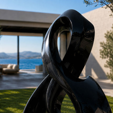 Polished stainless steel sculpture with reflective surface detail