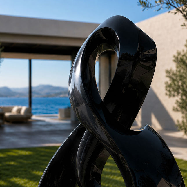 Polished stainless steel sculpture with reflective surface detail