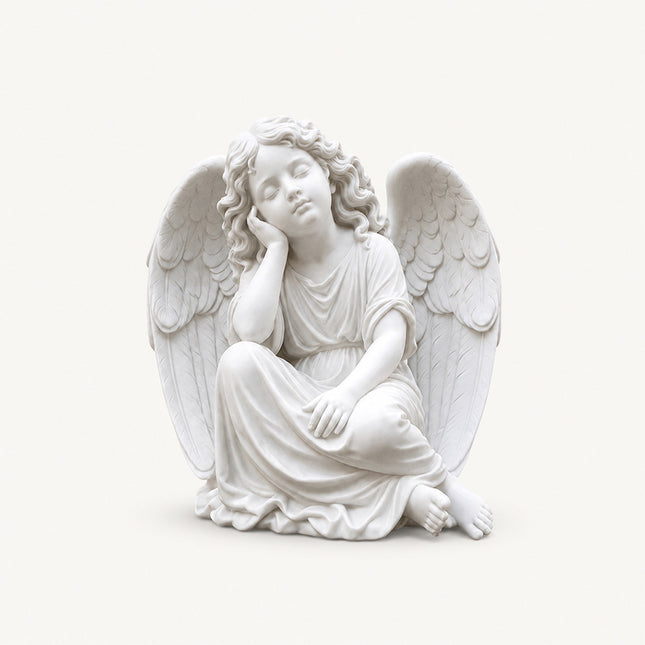 Resting angel statue carved in natural marble with classical religious sculpture details