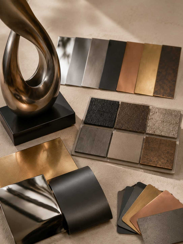 Custom sculpture finish samples showing polished, brushed, matte, and textured surface treatments for different visual effects