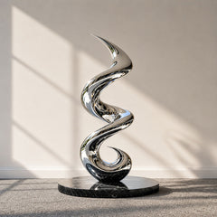 Mirror polished stainless steel spiral motion abstract sculpture with a flowing vertical form