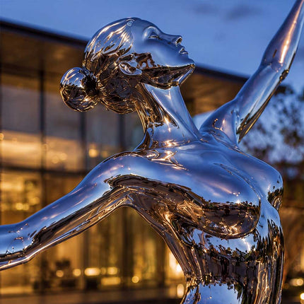 Detailed view of handcrafted stainless steel female sculpture with polished reflective finish