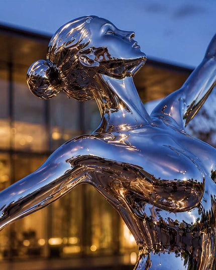 Detailed view of handcrafted stainless steel female sculpture with polished reflective finish